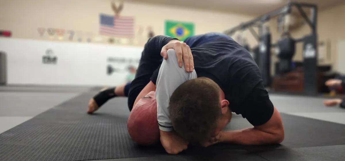 Two grapplers working on the mat during a Brazilian Jiu-Jitsu class at Glacier Grappling & MMA