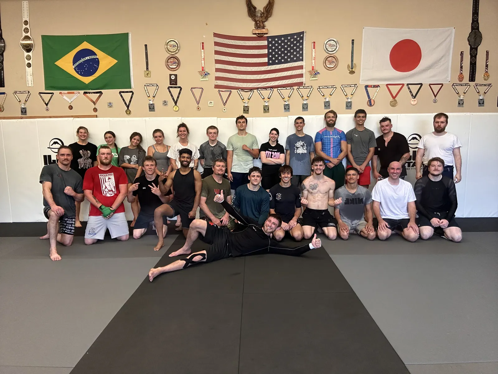 The Glacier Grappling & MMA team posing together on the mats after class